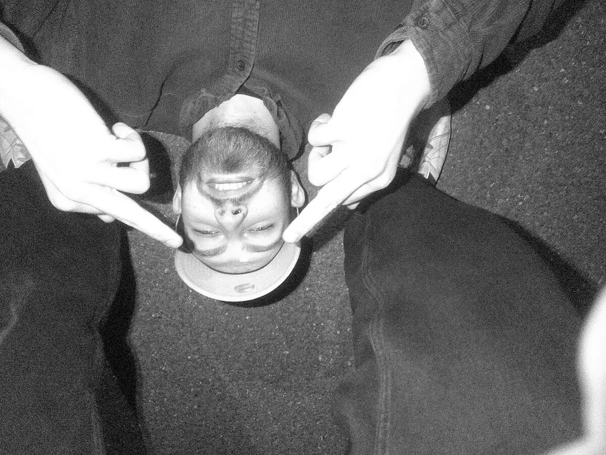 Arran Macdonald upside down, larking about with his band FLOK